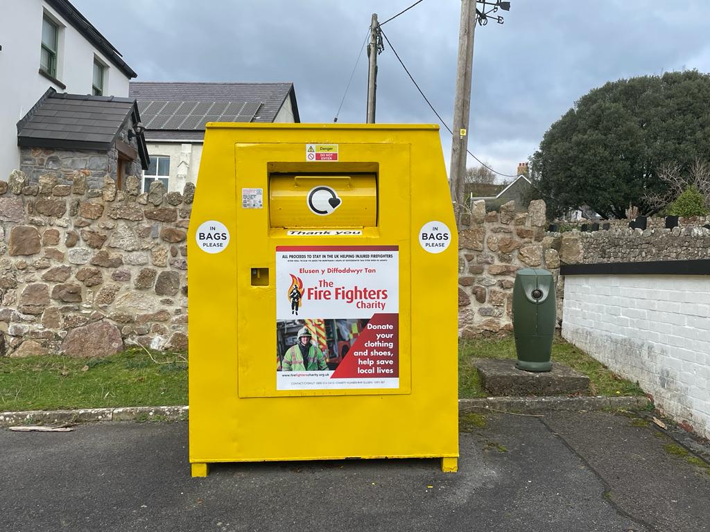 Image of yellow skip for recycling clothes at Reynoldston Fire Station