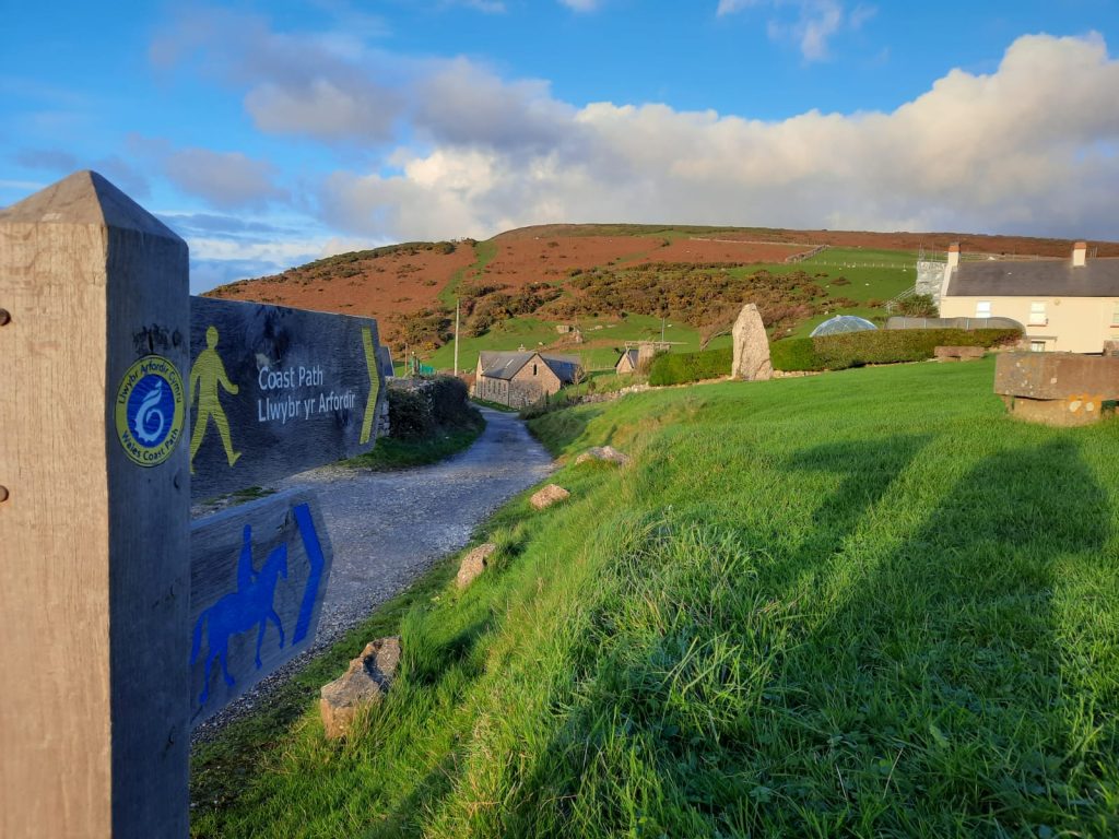 Footpath sign to coast path in Rhossili village.