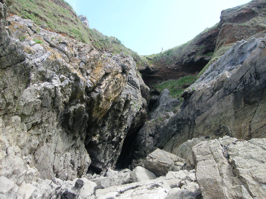Paviland cave from the shore at low tide.