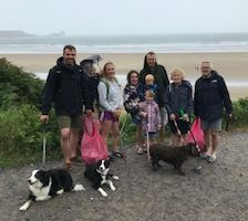 Group of people and dogs involved in the beach clean.