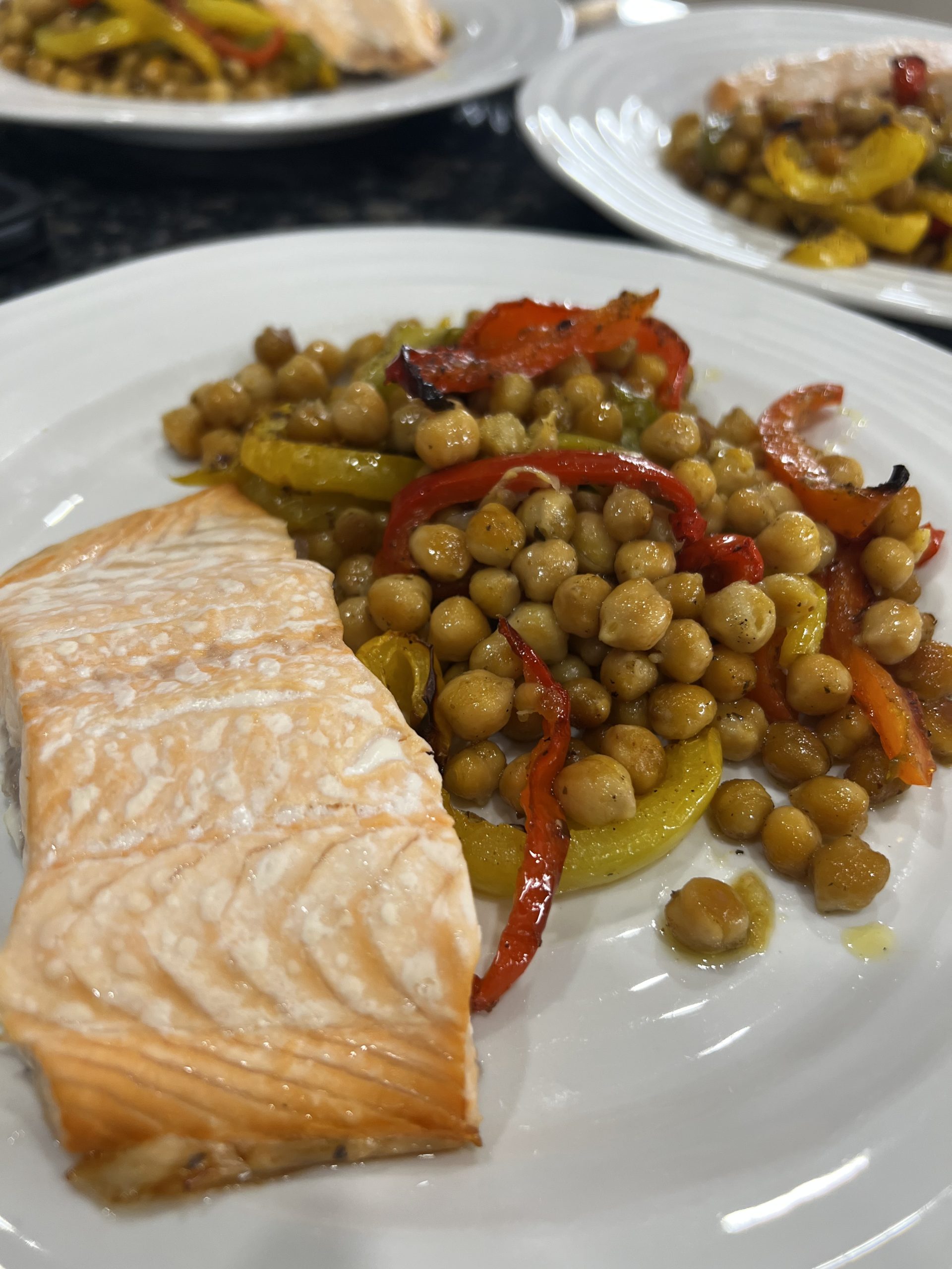Salmon fillets on plate with chick peas
